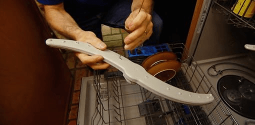 Cleaning the dishwasher spray arm