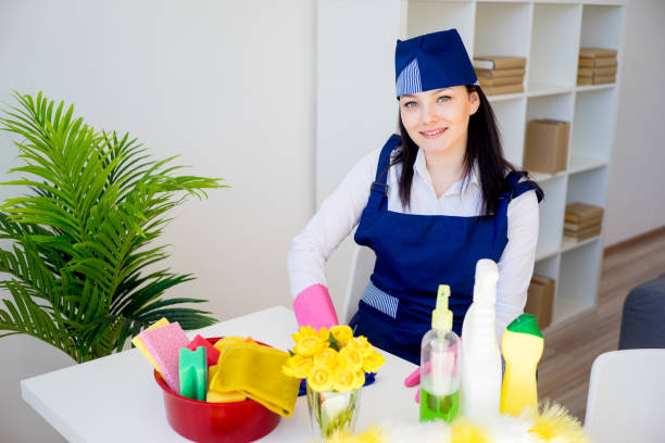 A maid is arranging flowers in the pot