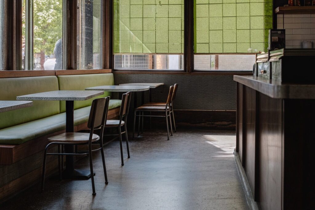 Clean cafe interior in NYC with seating area and coffee bar after professional cleaning