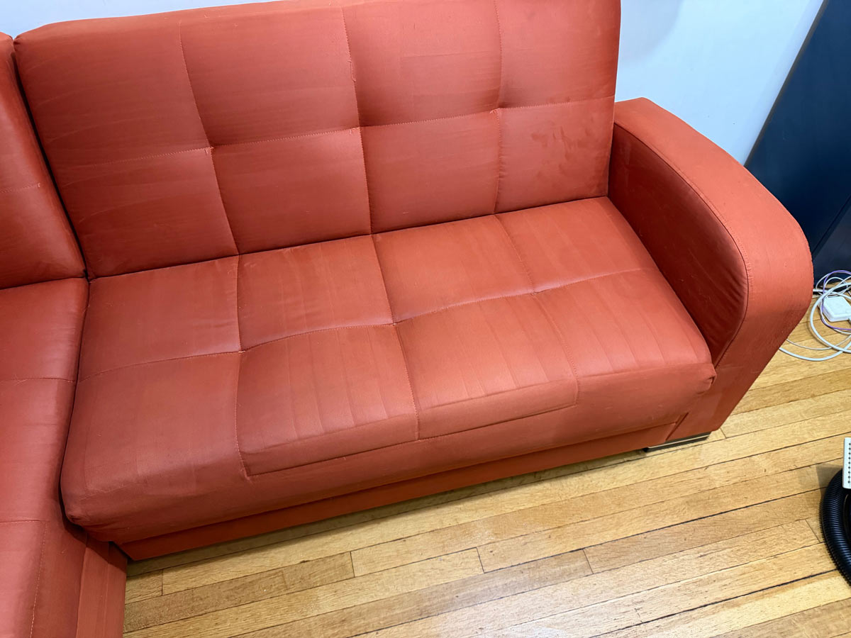 Microsuede sofa after professional stain removal — restored orange fabric without damage